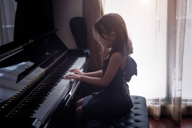 Child taking music lessons at home